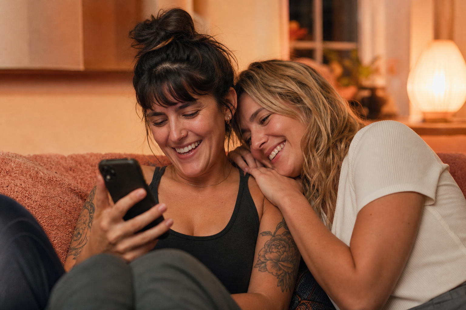Two women chatting warmly on a sofa